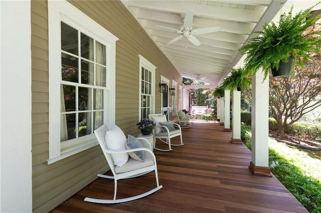 wooden terrace with ceiling fan and covered porch