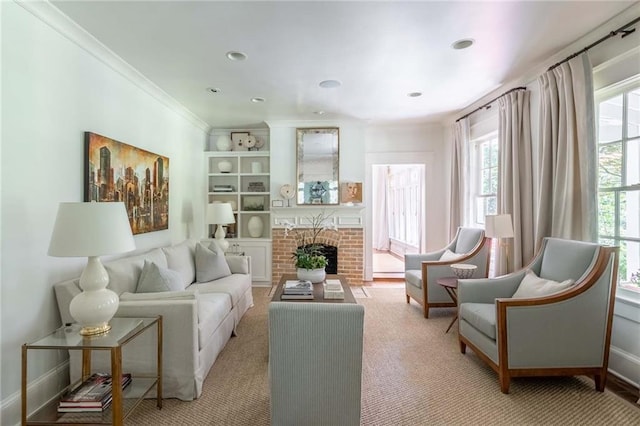 sitting room with light colored carpet, a brick fireplace, and ornamental molding