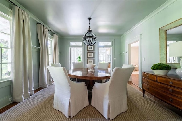 dining space featuring a notable chandelier and crown molding