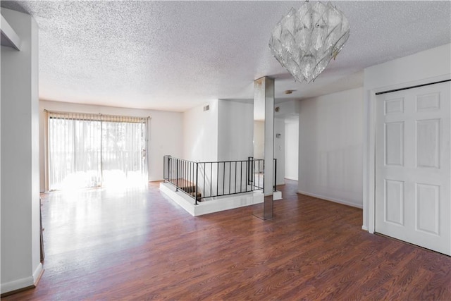 spare room featuring wood finished floors and baseboards