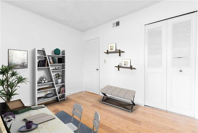 interior space with light wood-style flooring and visible vents