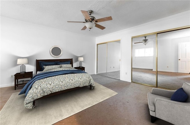 bedroom featuring carpet floors, a textured ceiling, and multiple closets