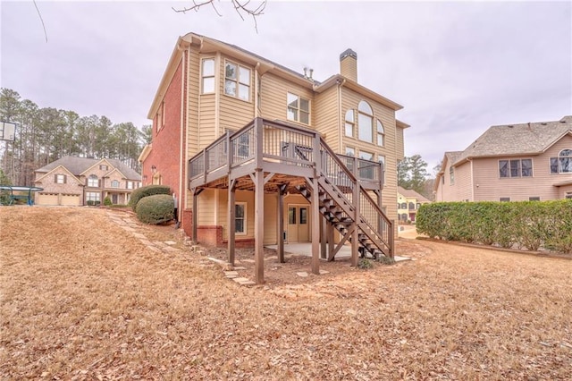 rear view of property featuring a deck