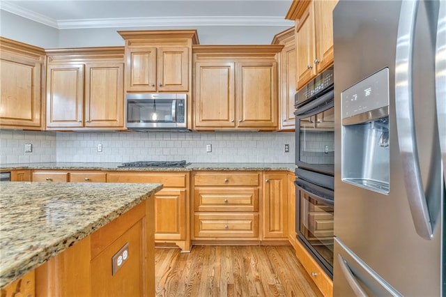 kitchen featuring crown molding, light stone counters, appliances with stainless steel finishes, light hardwood / wood-style floors, and backsplash