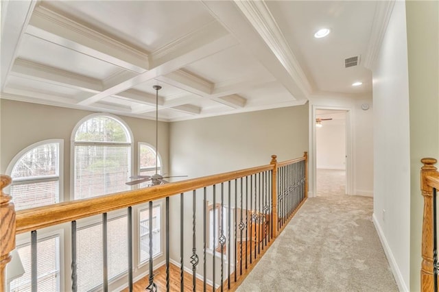 hallway with crown molding, coffered ceiling, light carpet, and beam ceiling