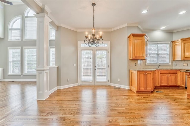 kitchen with light hardwood / wood-style flooring, a healthy amount of sunlight, and ornate columns