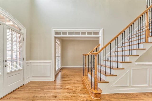 entryway with french doors and light hardwood / wood-style floors