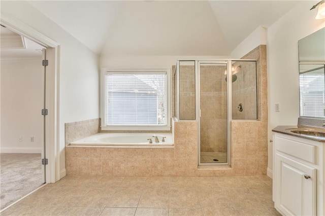 bathroom with vanity, lofted ceiling, plenty of natural light, and tile patterned floors