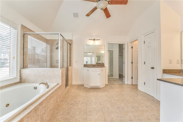 bathroom featuring vanity, lofted ceiling, shower with separate bathtub, and a wealth of natural light