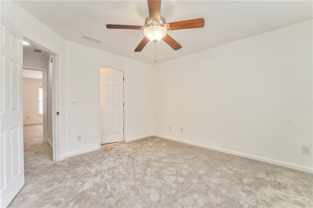 carpeted empty room with ceiling fan