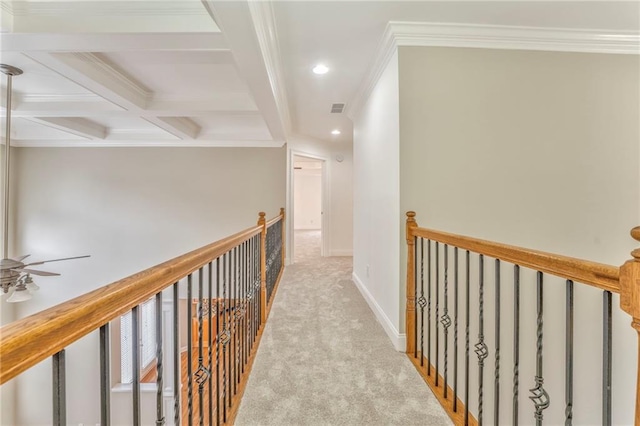 hall featuring beamed ceiling, ornamental molding, coffered ceiling, and light carpet