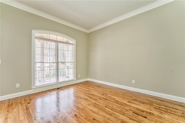 unfurnished room with crown molding and light hardwood / wood-style flooring