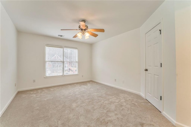 spare room with light carpet and ceiling fan