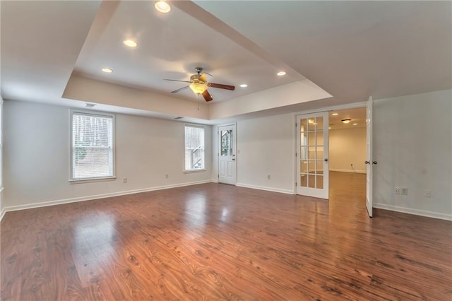 unfurnished room with dark hardwood / wood-style floors, ceiling fan, and french doors