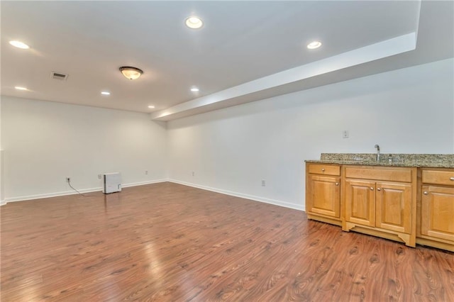 spare room with sink and dark hardwood / wood-style floors