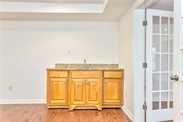 interior space with sink and hardwood / wood-style floors