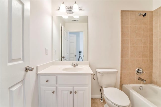 full bathroom featuring tiled shower / bath combo, vanity, and toilet