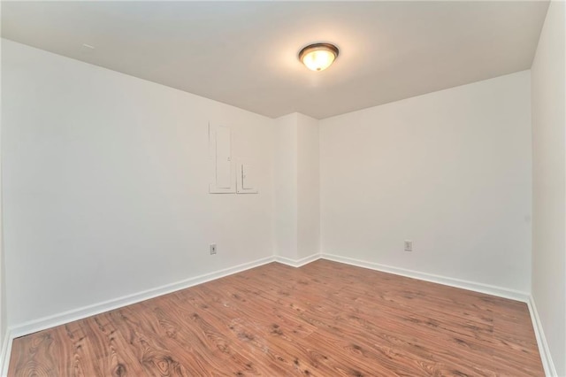 spare room with wood-type flooring