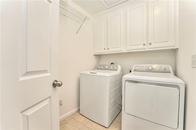 laundry area with cabinets, washing machine and clothes dryer, and light tile patterned floors