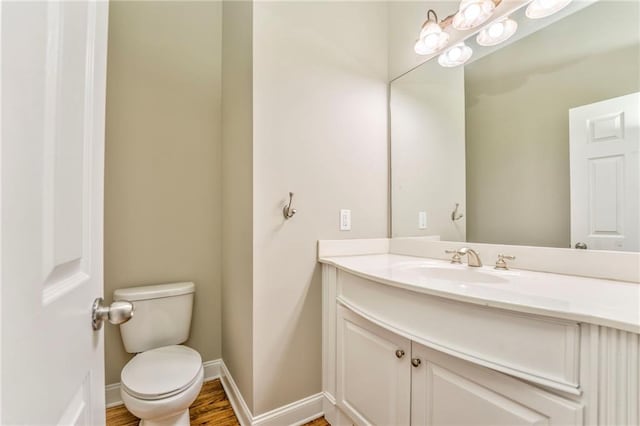 bathroom with vanity, hardwood / wood-style floors, and toilet