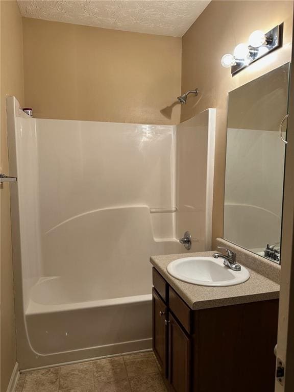 bathroom featuring vanity, shower / tub combination, and a textured ceiling