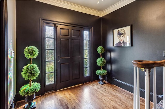 foyer with ornamental molding and wood-type flooring