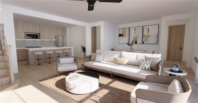 living room with ceiling fan and light hardwood / wood-style flooring