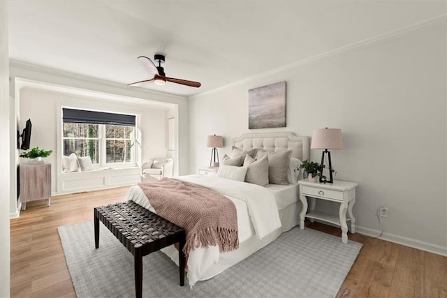 bedroom with ceiling fan, ornamental molding, and light hardwood / wood-style floors