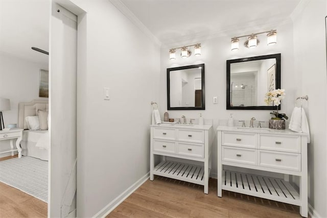 bathroom with hardwood / wood-style floors, vanity, and ornamental molding