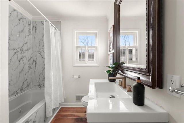 full bathroom featuring wood-type flooring, vanity, toilet, shower / tub combo with curtain, and crown molding