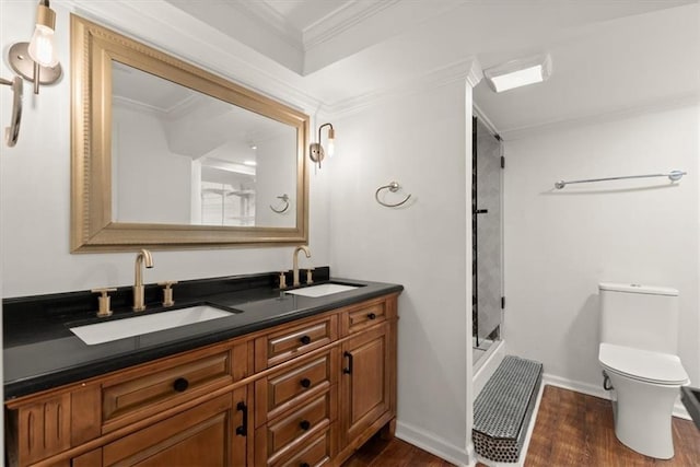 bathroom with vanity, crown molding, hardwood / wood-style floors, and walk in shower