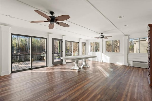 unfurnished sunroom featuring ceiling fan and a wall unit AC