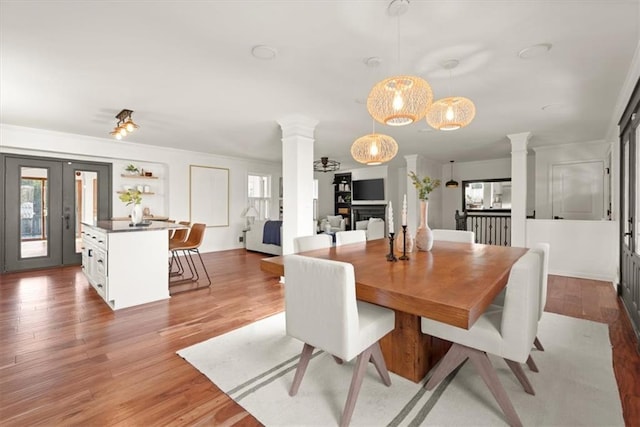 dining space featuring ornate columns and hardwood / wood-style flooring