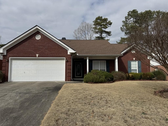 single story home featuring a garage and a front lawn