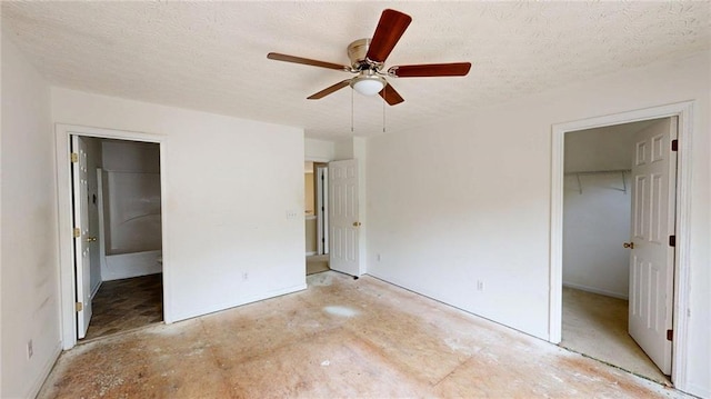 176 Silver Fox Trl, Dallas, GA 30157 - unfurnished bedroom featuring a spacious closet, a closet, a textured ceiling, baseboards, and ceiling fan