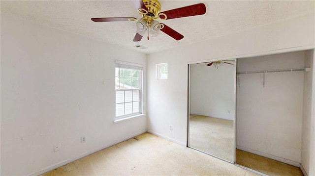 176 Silver Fox Trl, Dallas, GA 30157 - unfurnished bedroom featuring a closet, a textured ceiling, baseboards, ceiling fan, and carpet floors