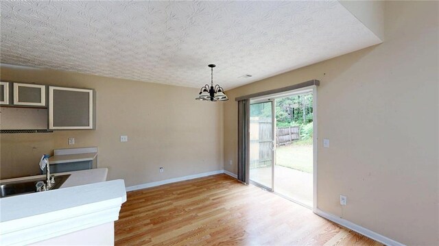 176 Silver Fox Trl, Dallas, GA 30157 - dining area with a chandelier, light wood finished floors, and baseboards