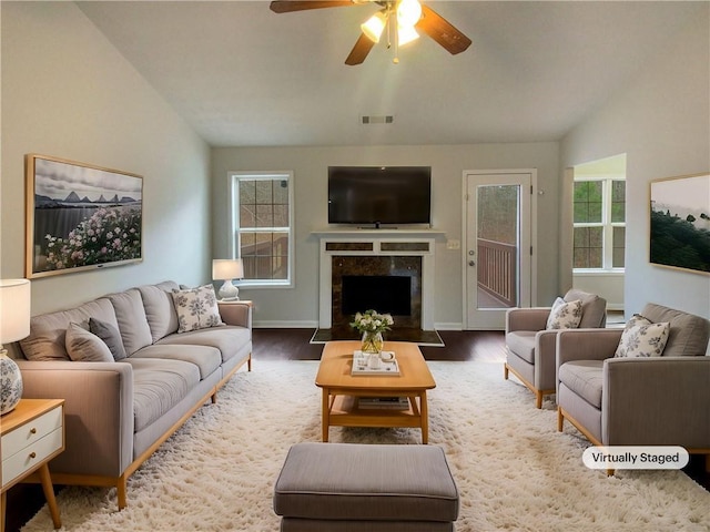 living room with hardwood / wood-style floors, vaulted ceiling, and ceiling fan