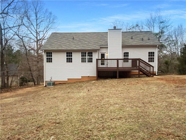 back of house featuring a wooden deck, cooling unit, and a lawn