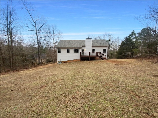 back of property featuring a yard and a deck