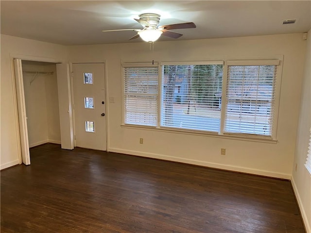 foyer featuring a healthy amount of sunlight, dark hardwood / wood-style floors, and ceiling fan