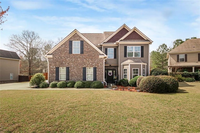 view of front facade featuring brick siding and a front lawn