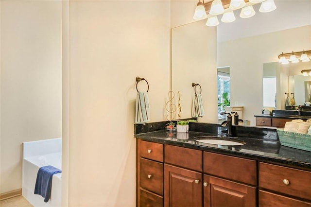 full bathroom featuring vanity and a garden tub