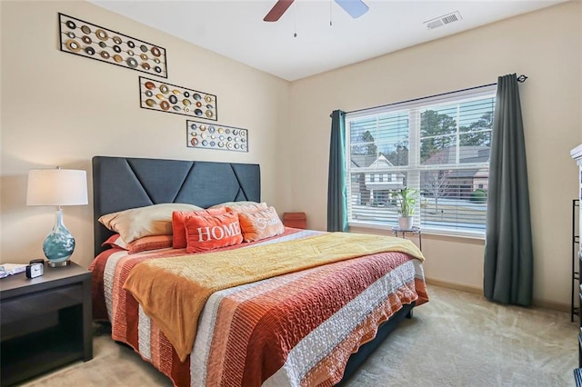 bedroom with visible vents, light carpet, baseboards, and a ceiling fan