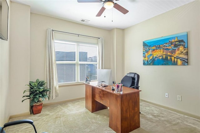 office space with visible vents, baseboards, ceiling fan, and carpet floors