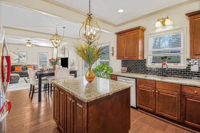 kitchen with tasteful backsplash, wood finished floors, stainless steel appliances, and a sink