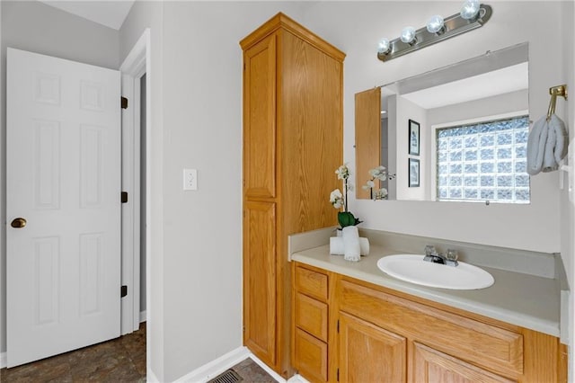 bathroom with vanity and baseboards