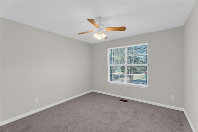 spare room featuring visible vents, carpet flooring, baseboards, and ceiling fan