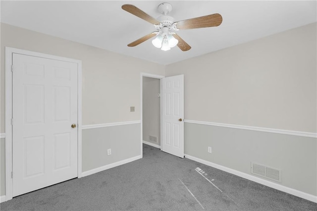 unfurnished bedroom with visible vents, baseboards, carpet floors, and ceiling fan