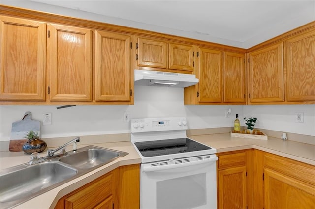 kitchen with under cabinet range hood, a sink, white electric range oven, brown cabinetry, and light countertops